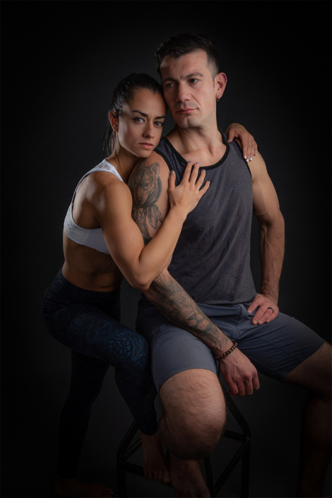 Dynamic in-studio portrait of a fit and active couple, highlighting their athletic strength and connection.