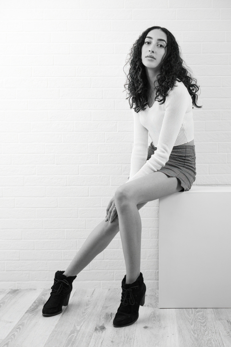 Captivating black and white in-studio portrait of a female model, capturing her timeless allure.