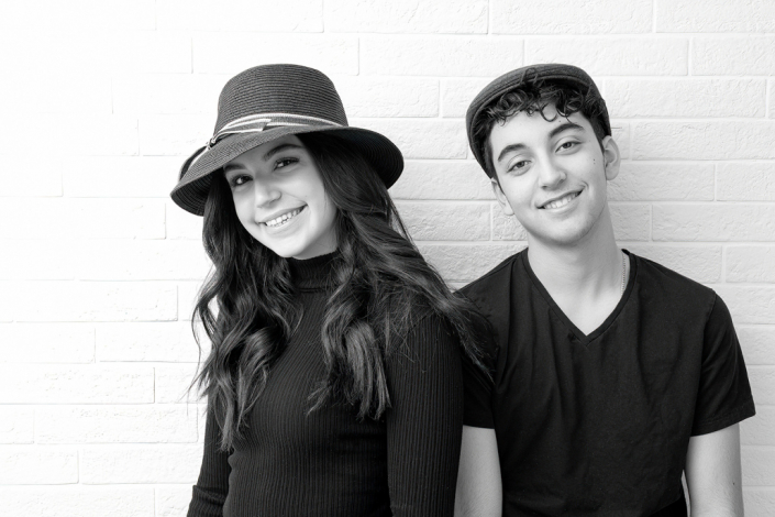 Classic black and white in-studio portrait of a brother and sister, capturing their timeless bond.